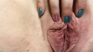 Brunette woman checks how deep her tongue can reach in the slit