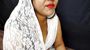 A cute girl in opt beautiful dress is exposing herself on camera