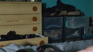 A cute girl in pink lingerie poses provocatively on a white background