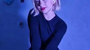 A cute little girl playing with a big toy penis